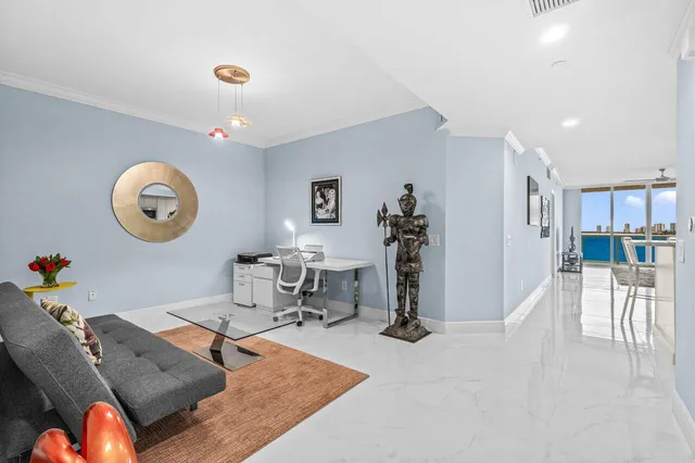 a living room with furniture a clock and a table