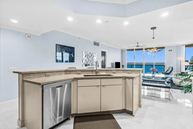a kitchen with granite countertop white cabinets stainless steel appliances and a sink