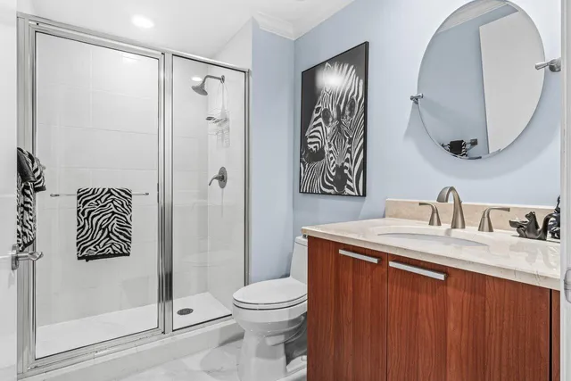 a bathroom with a sink a toilet and shower