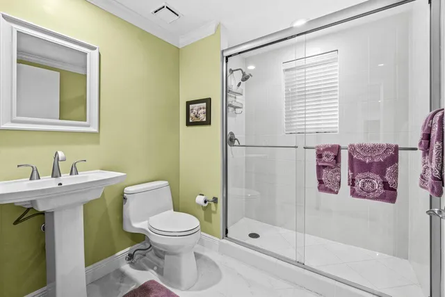 a bathroom with a sink vanity mirror and toilet