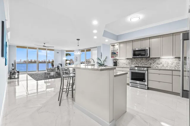 a kitchen with a white cabinets and chairs
