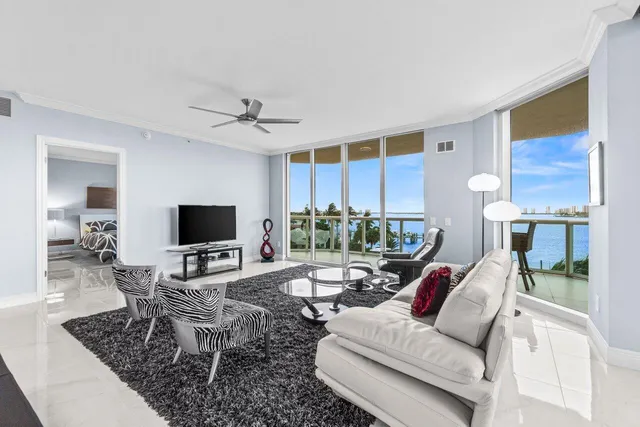 a living room with furniture a flat screen tv and a table