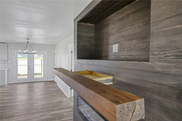 a view of kitchen with granite countertop cabinets and wooden floor
