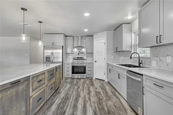 a kitchen with stainless steel appliances sink refrigerator and microwave
