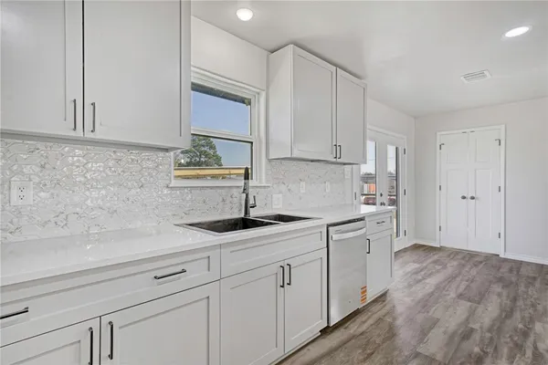 a kitchen with a sink and cabinets