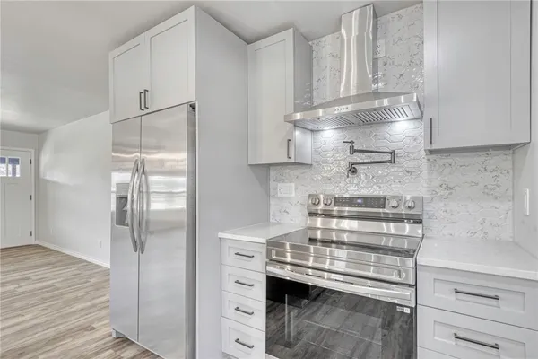 a kitchen with a counter space a sink and appliances