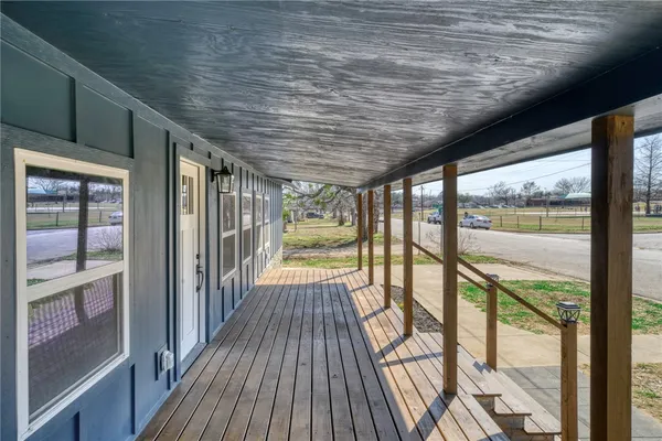 a view of balcony with wooden floor