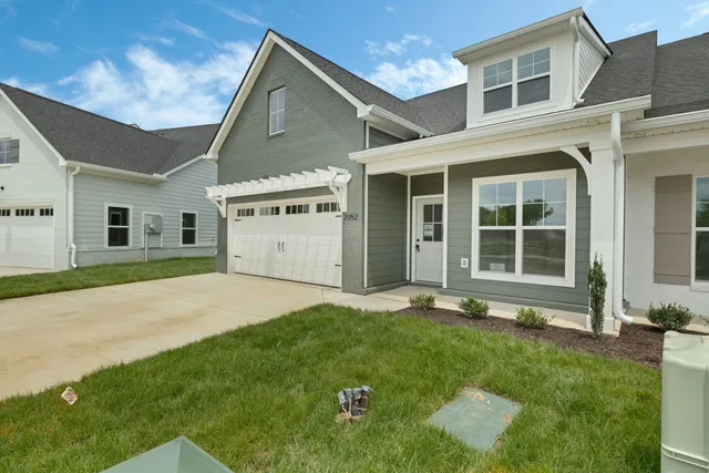 a backyard of a house with large garden and plants