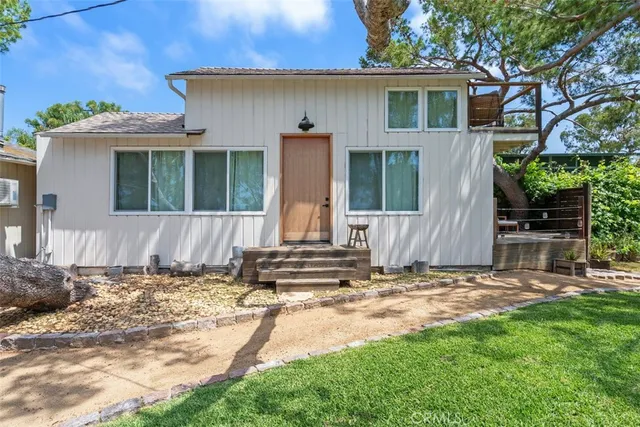 a view of a house with a yard patio and a garden