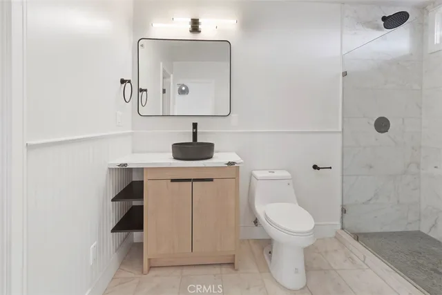 a kitchen with granite countertop a sink a stove and wooden cabinets