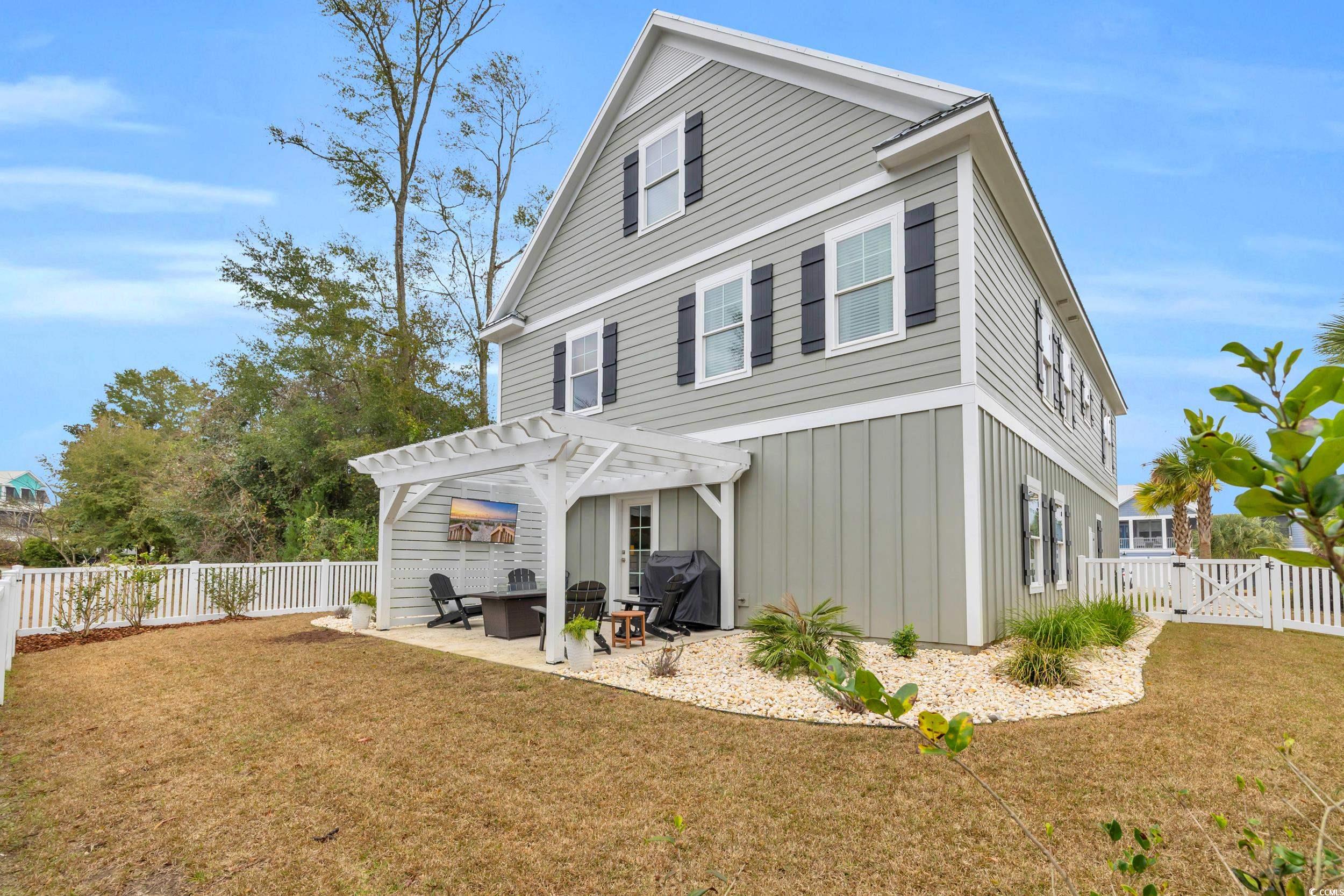 22 Trigger Fish Lane Murrells Inlet, SC 29576 - Photo 35 of 39 Back of property with a pergola, a yard, and a patio