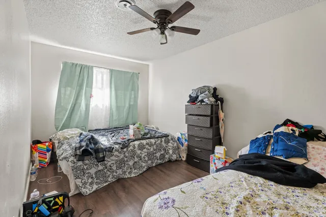 a bed room with furniture and wooden floor