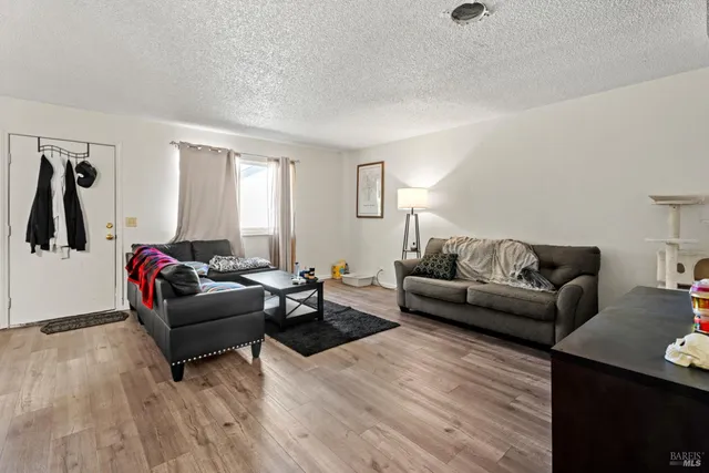 a spacious bedroom with a bed a couch and a flat screen tv