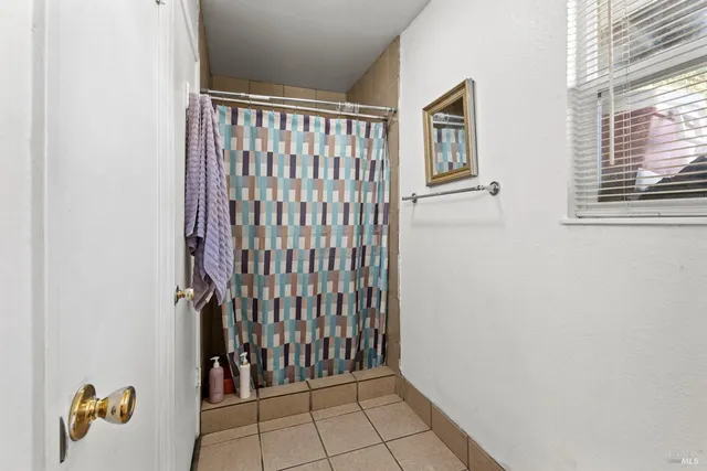 a bathroom with a granite countertop sink a toilet and a mirror