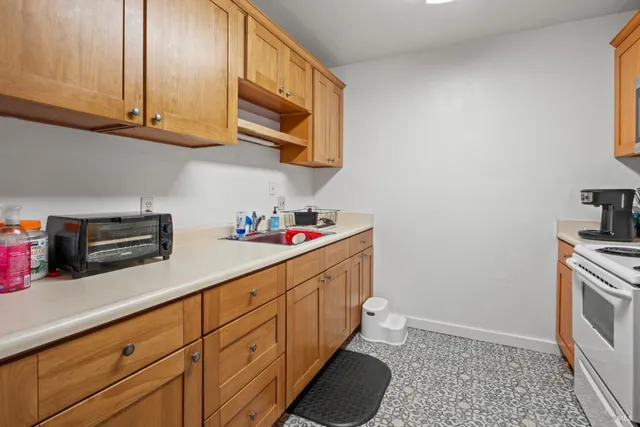 a kitchen with stainless steel appliances granite countertop a refrigerator and a stove