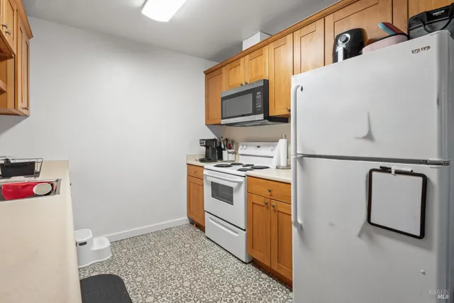 a living room with furniture a rug and a book shelf