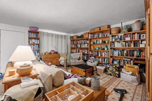 a living room with furniture and a bed