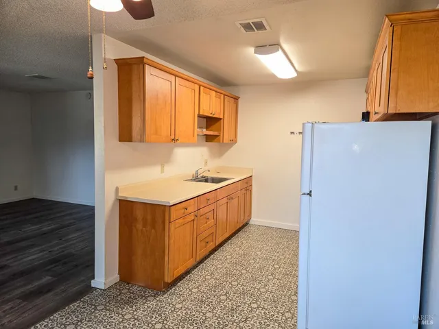 a view of room with a ceiling fan and a window