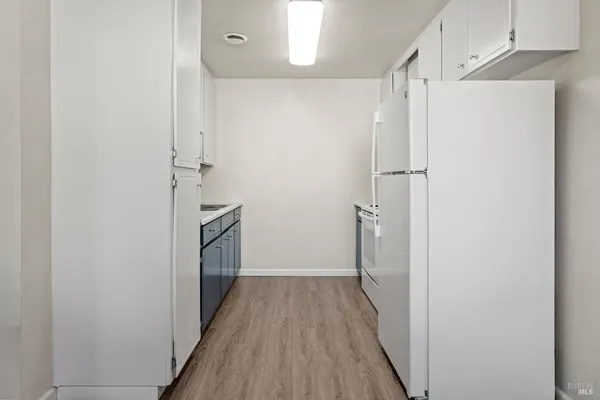 a kitchen with a sink cabinets and appliances