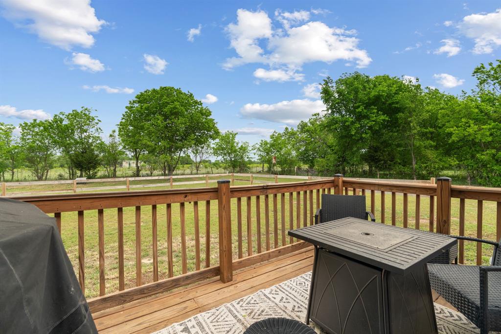 360 County Road 4358 Decatur, TX 76234 - Photo 26 of 38 Deck with area for grilling, a lawn, and a fenced backyard