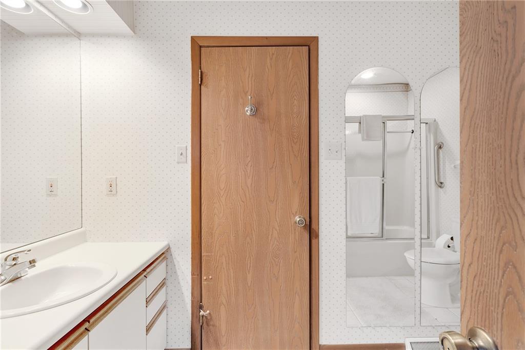 108 Spring Run Drive Monroeville, PA 15146 - Photo 21 of 25 This is the full bath containing a tub/shower, sink and commode. If you look in the mirror you can see the reflection. The bath is situated between the two bedrooms. You are looking at the entry to the master bedroom. The bathroom has a linen closet.