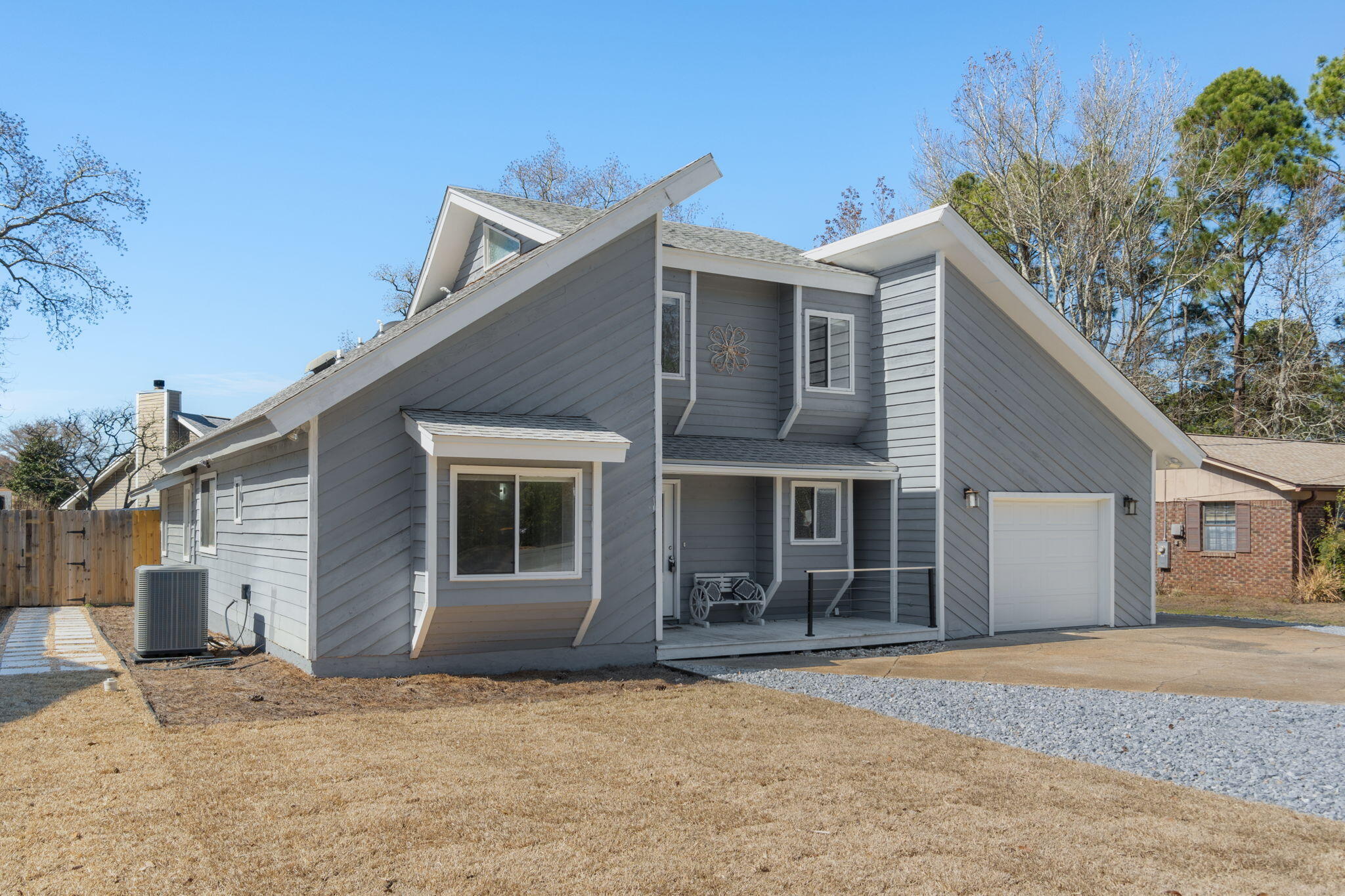 a house that has a tree in front of it