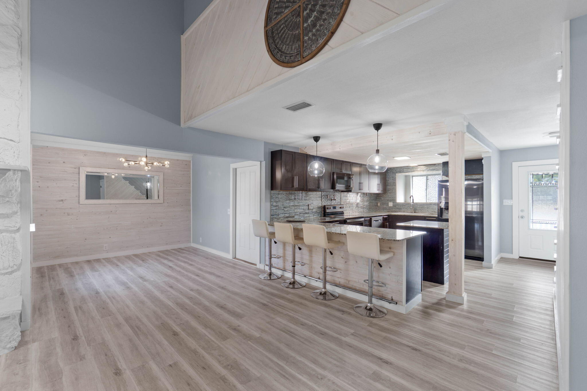 41 Solar Street Mary Esther, FL 32569 - Photo 11 of 40 a kitchen with stainless steel appliances granite countertop a stove top oven a sink dishwasher and a refrigerator with wooden floor