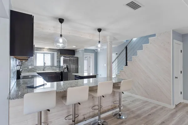 a dining room with furniture and wooden floor