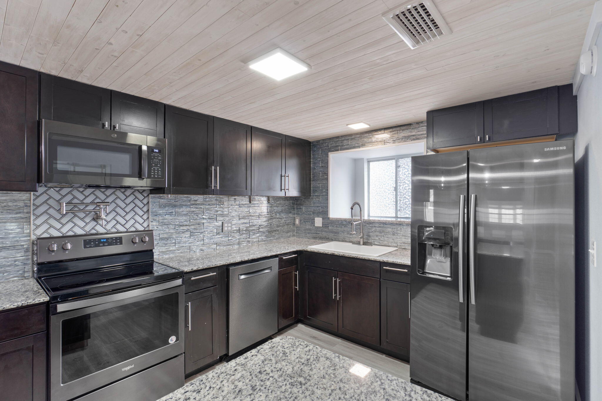 41 Solar Street Mary Esther, FL 32569 - Photo 16 of 40 a kitchen with stainless steel appliances granite countertop a sink stove and refrigerator