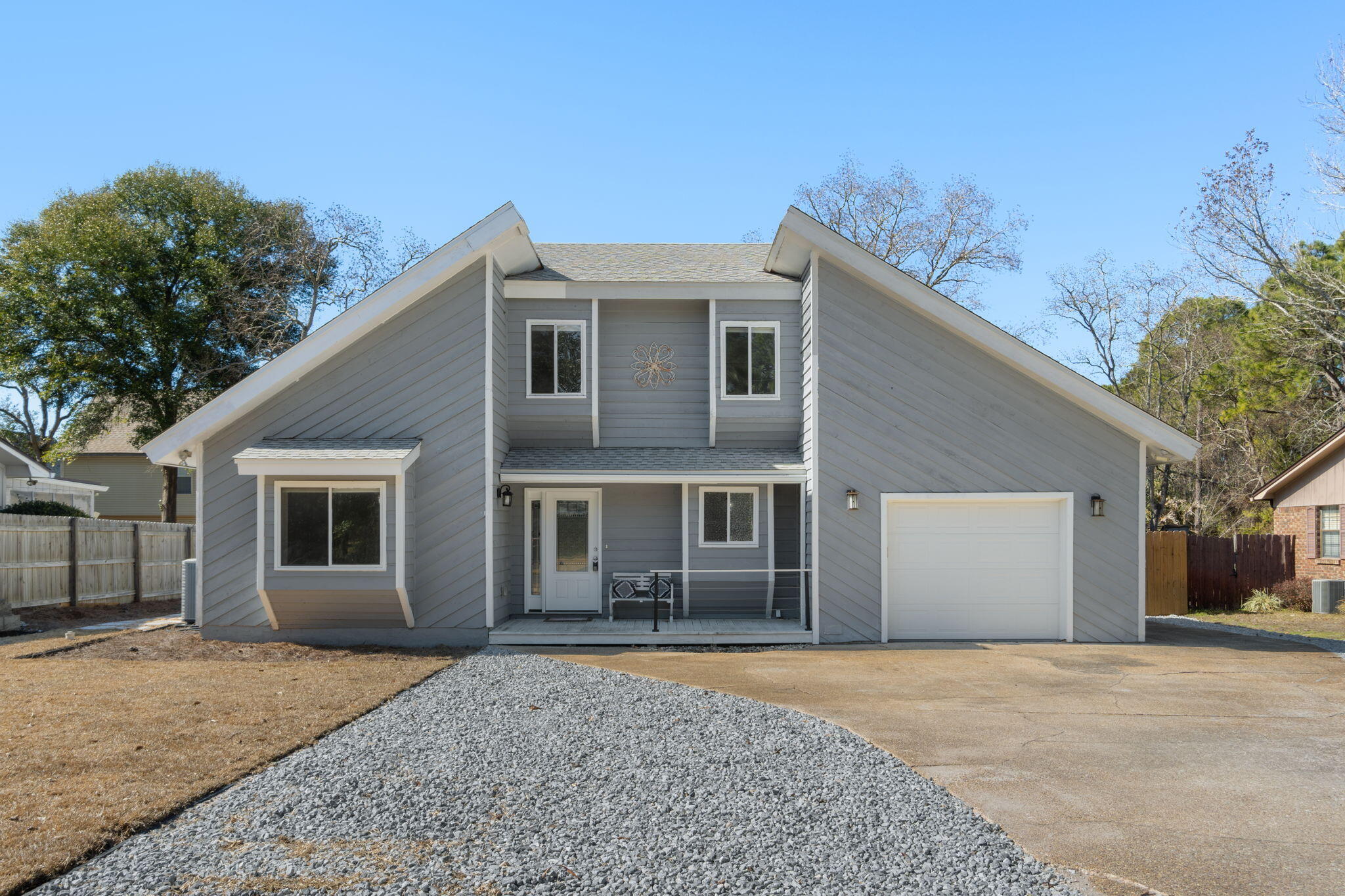 41 Solar Street Mary Esther, FL 32569 - Photo 2 of 40 a front view of a house with a yard and garage