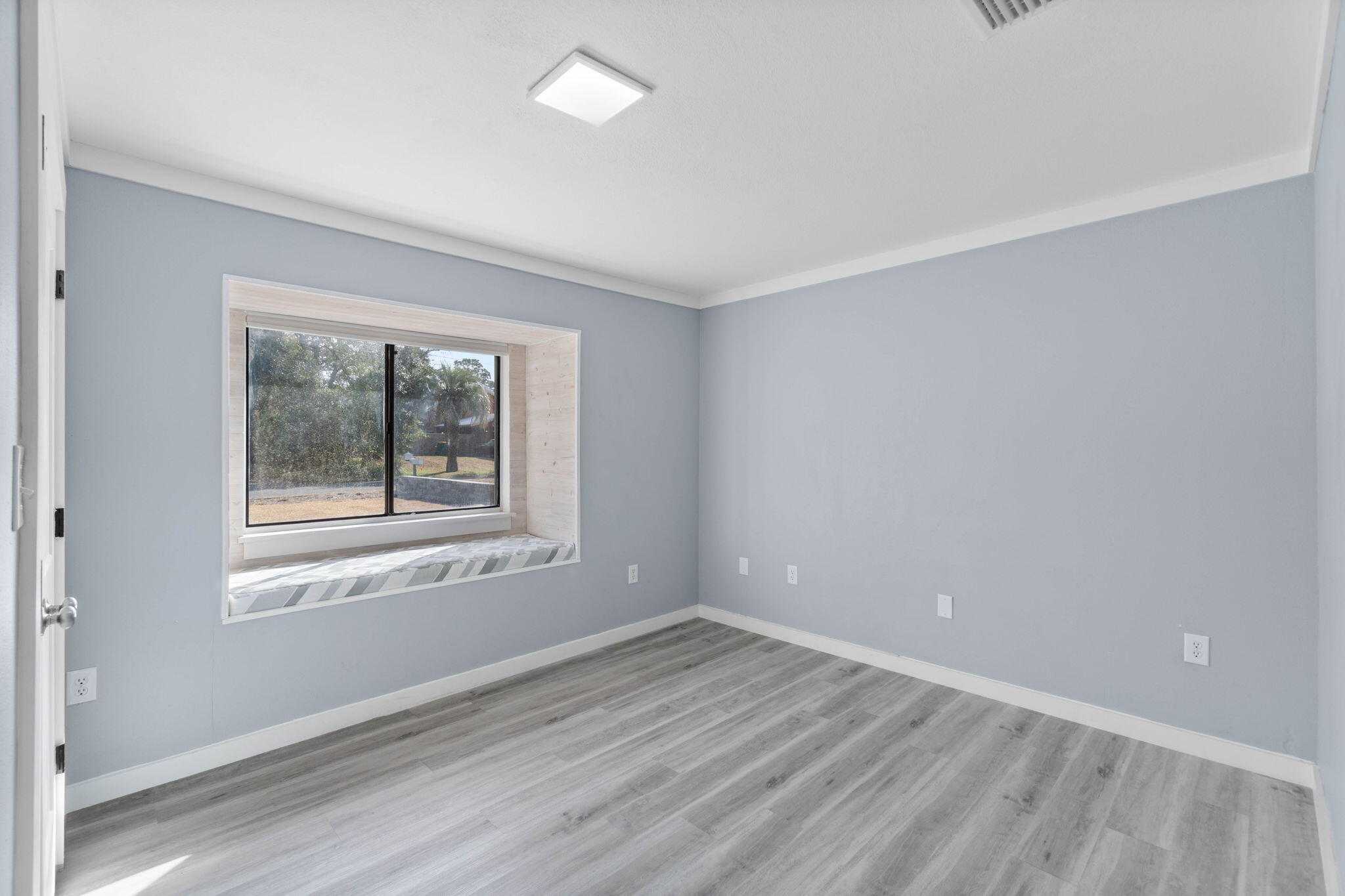 41 Solar Street Mary Esther, FL 32569 - Photo 21 of 40 a view of an empty room with wooden floor and a window