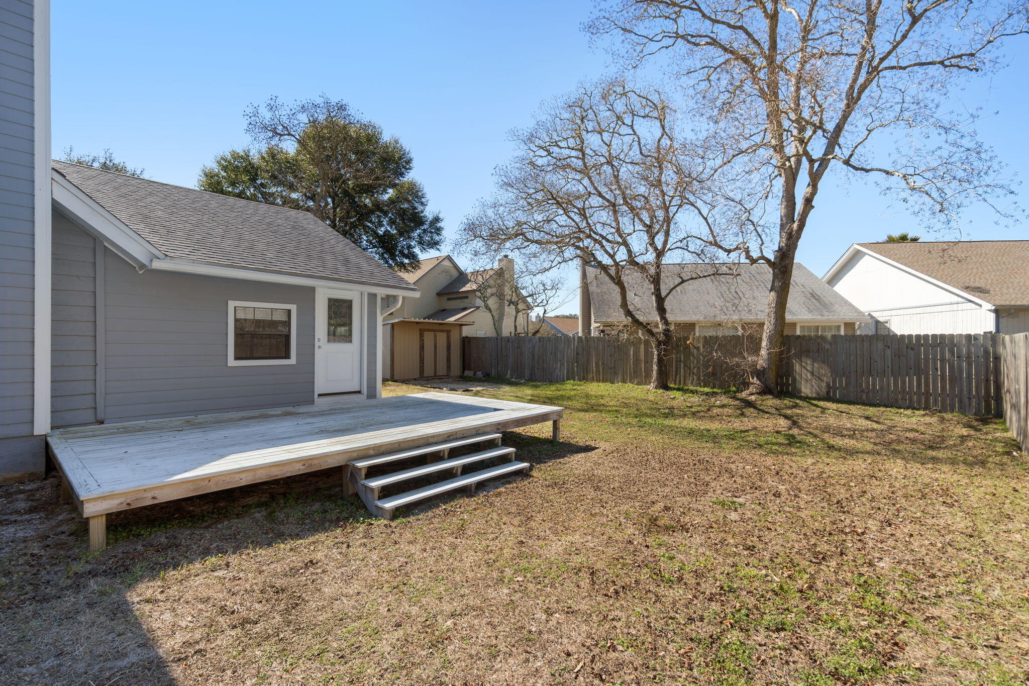 41 Solar Street Mary Esther, FL 32569 - Photo 36 of 40 a backyard of a house with trees and outdoor space