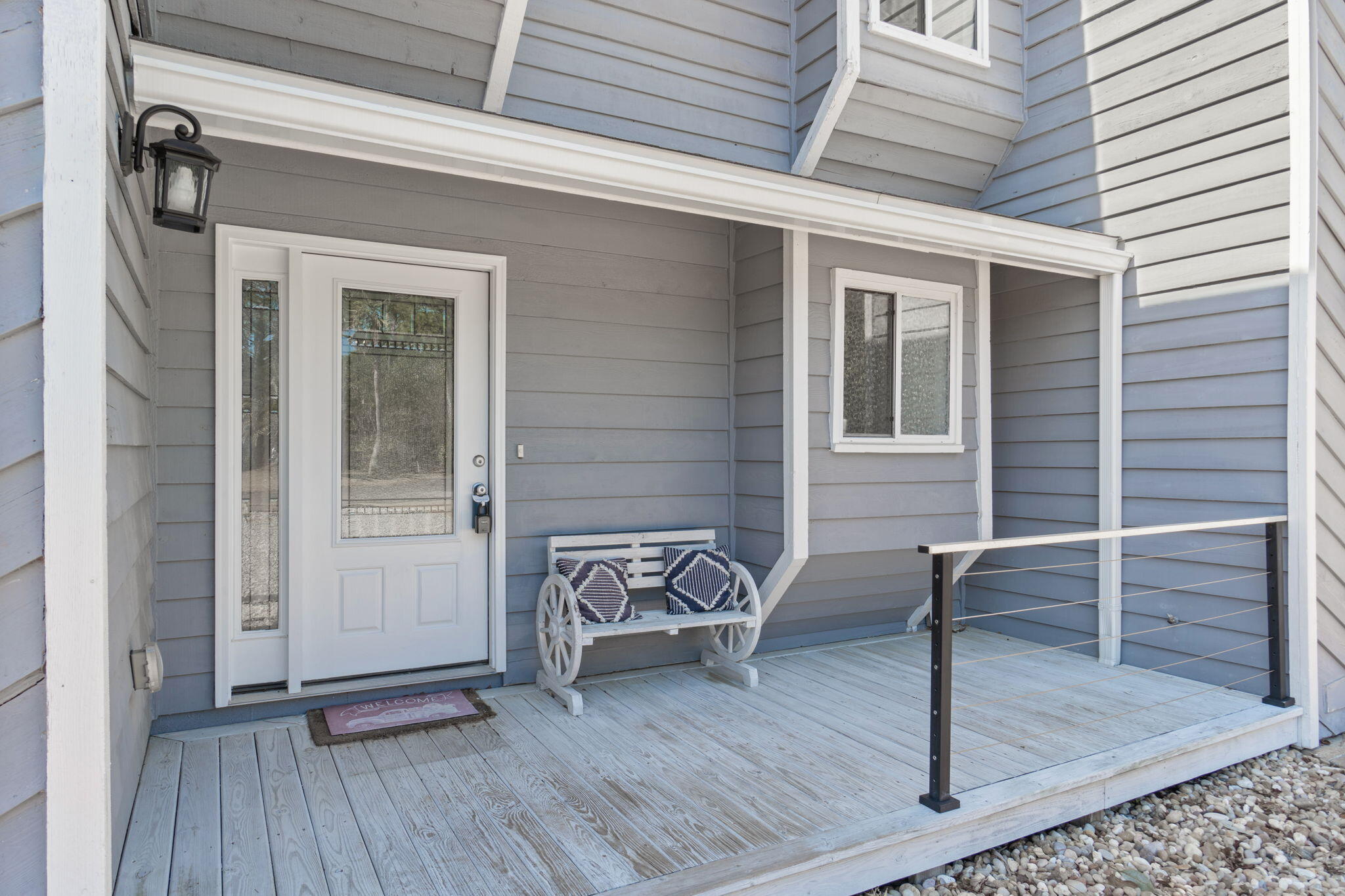 41 Solar Street Mary Esther, FL 32569 - Photo 4 of 40 a view of a house with a door and wooden bench