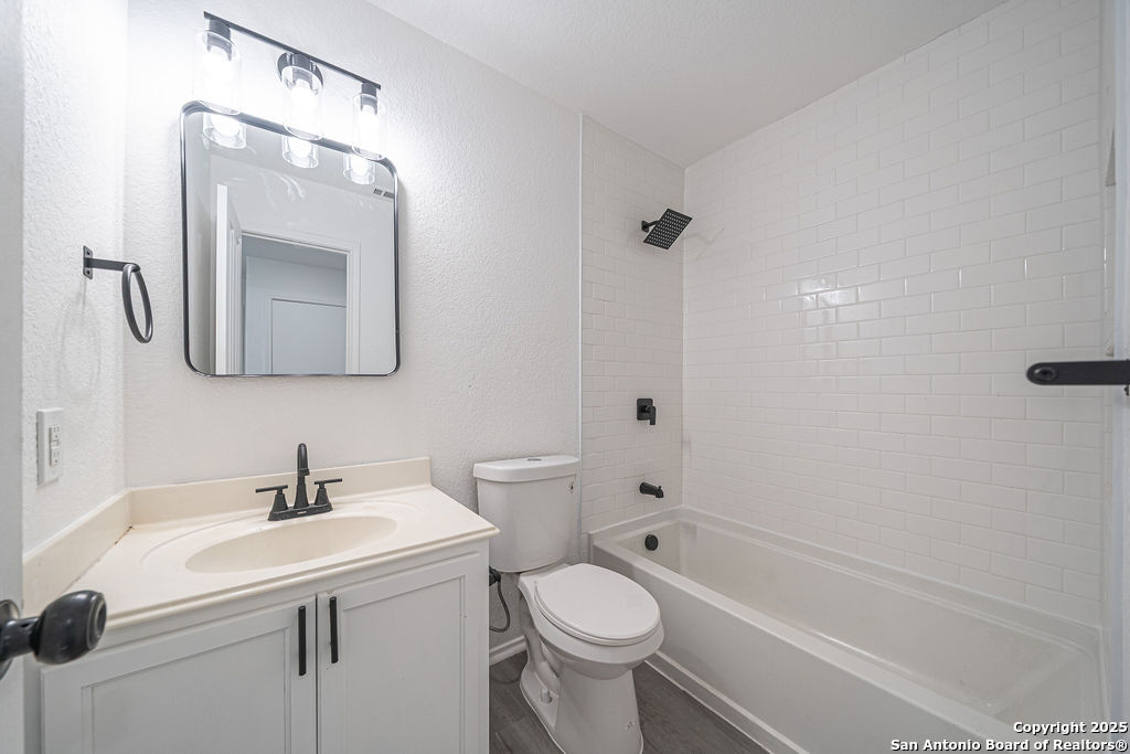 3914 Cinco Rios San Antonio, TX 78223 - Photo 8 of 12 a bathroom with a sink a toilet and shower