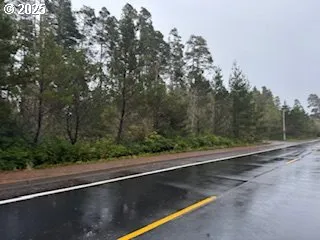 a view of a street with trees in front of it