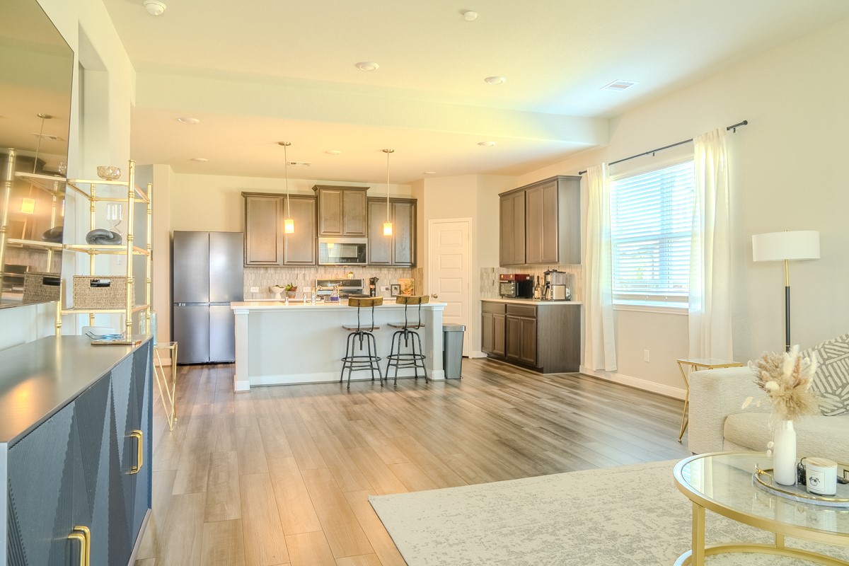 2617 Indigo Harvest Trail Pearland, TX 77089 - Photo 12 of 32 a kitchen with stainless steel appliances wooden floor and large windows