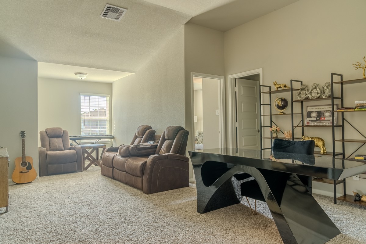 2617 Indigo Harvest Trail Pearland, TX 77089 - Photo 18 of 32 a living room with furniture a lamp and a window