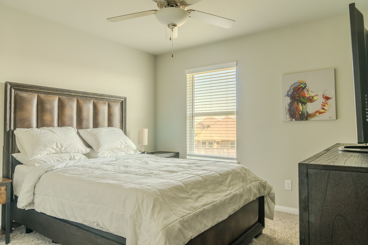 2617 Indigo Harvest Trail Pearland, TX 77089 - Photo 25 of 32 a bed sitting in a bedroom next to a window