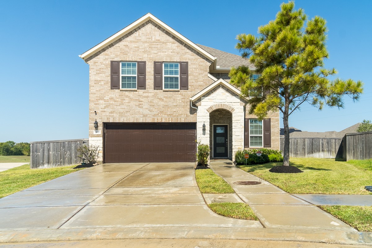 2617 Indigo Harvest Trail Pearland, TX 77089 - Photo 32 of 32 a front view of a house with a yard and garage