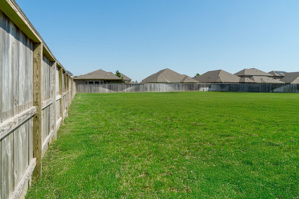 2617 Indigo Harvest Trail Pearland, TX 77089 - Photo 4 of 32 a view of a big house with a big yard and large trees