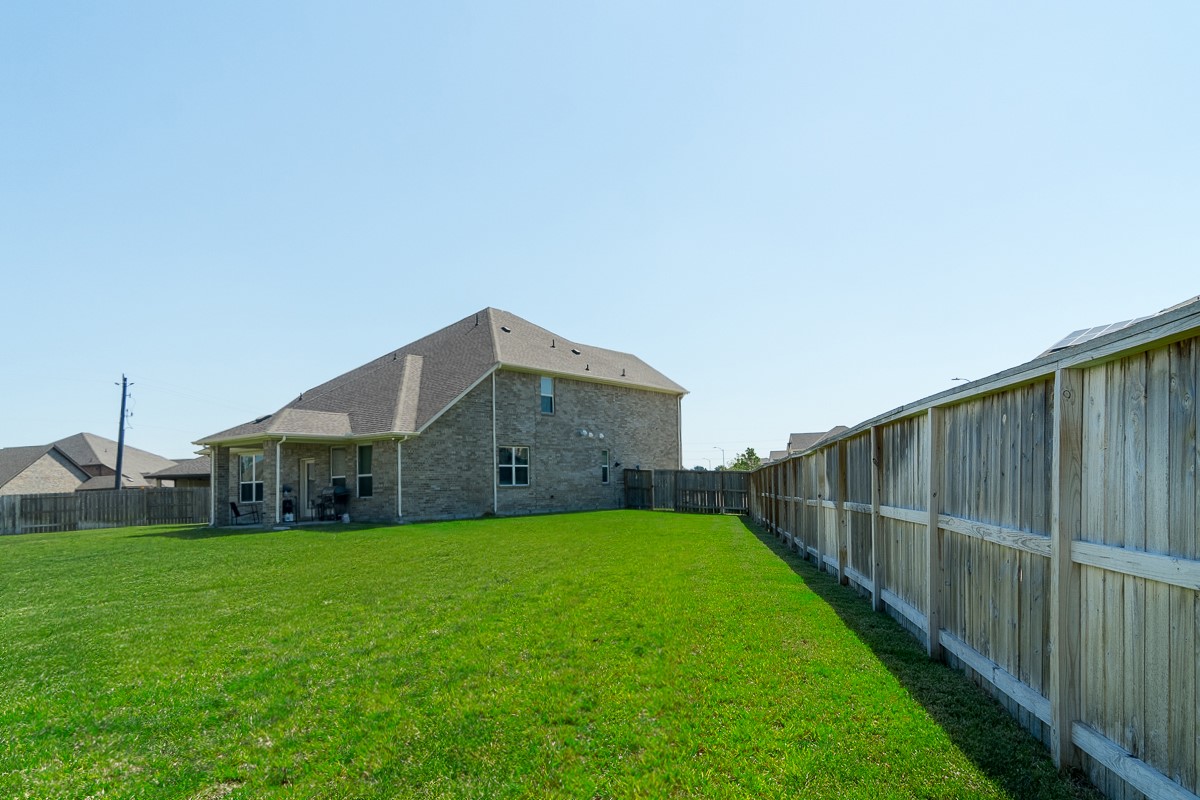 2617 Indigo Harvest Trail Pearland, TX 77089 - Photo 6 of 32 a view of a house with a big yard and a large tree
