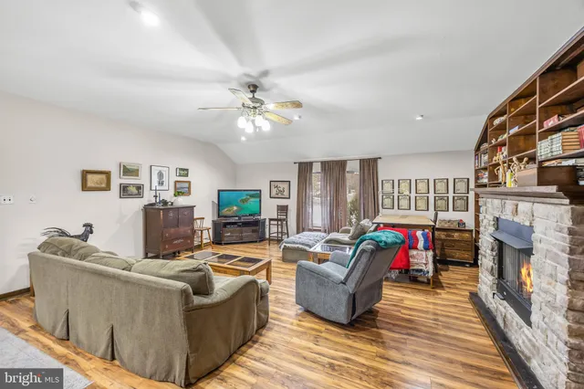 a living room with furniture a fireplace and a flat screen tv