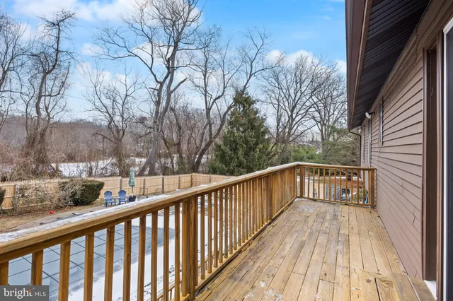 a view of a patio with table and chairs with wooden floor and fence