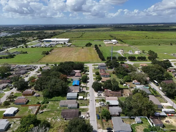 an aerial view of a houses with outdoor space and lake view