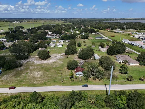 an aerial view of residential houses with outdoor space and seating