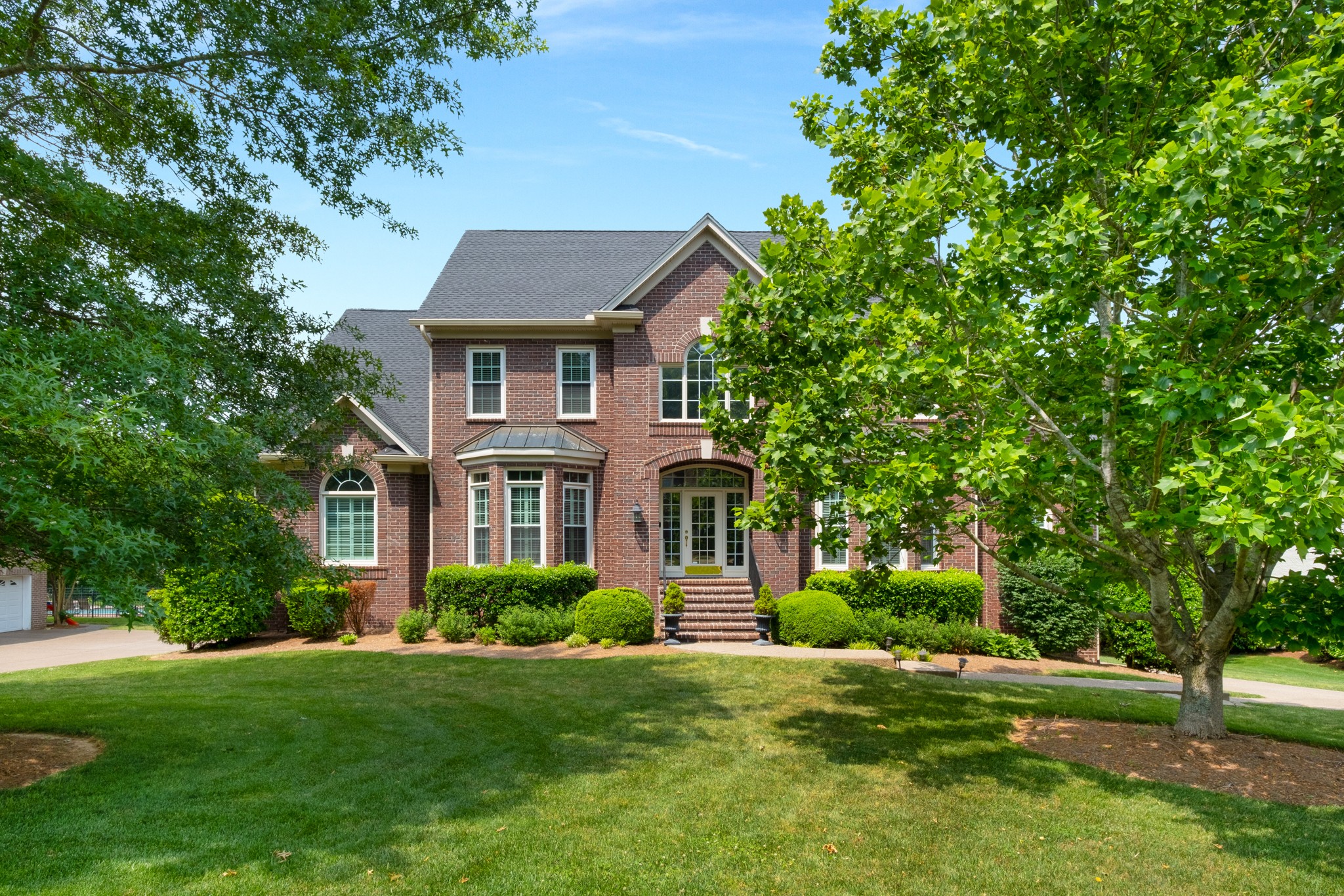 a front view of a house with a yard