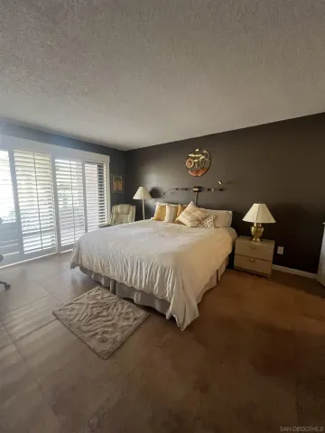 a bedroom with a bed and glass window