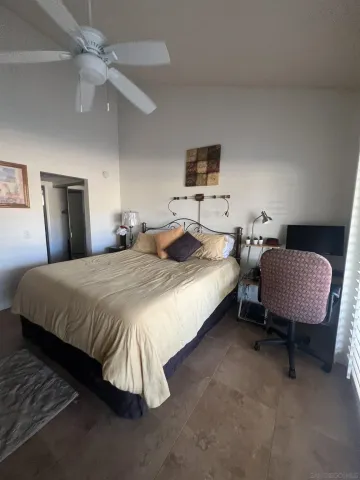 a bedroom with a bed a bed and a chair