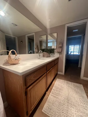 a room with sink and mirror