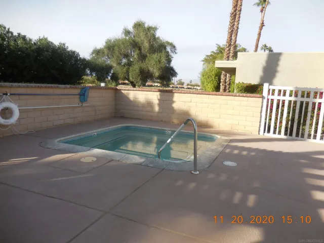 a view of a swimming pool with a yard